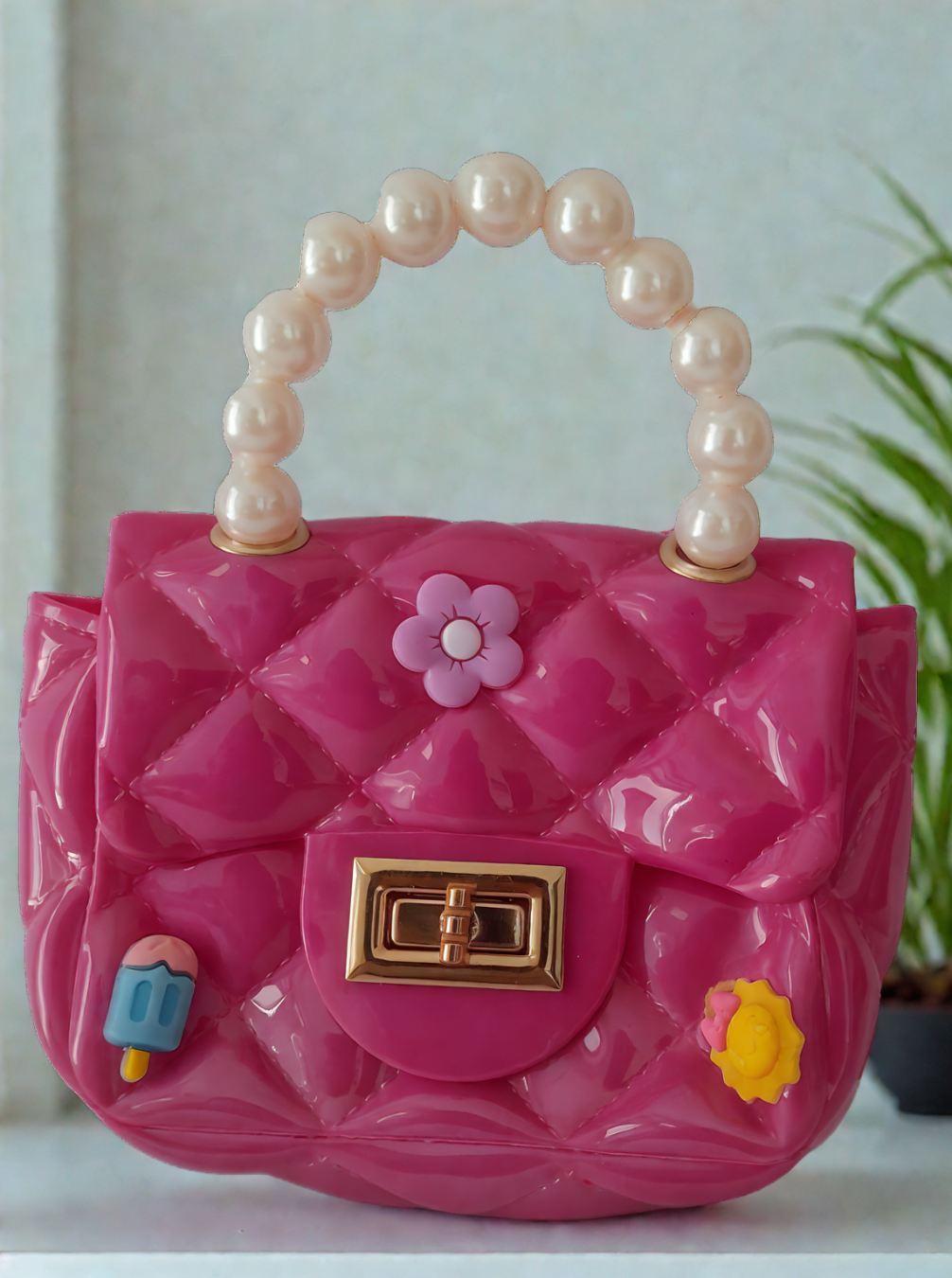 Silicon pearl sling bag with golden chain strap and pearl handle – stylish and durable mini shoulder bag for girls and women in bright pink, available online in India.
