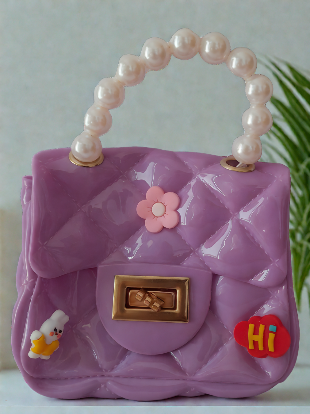 Silicon pearl sling bag with golden chain strap and pearl handle – stylish and durable mini shoulder bag for girls and women in light purple, available online in India.
