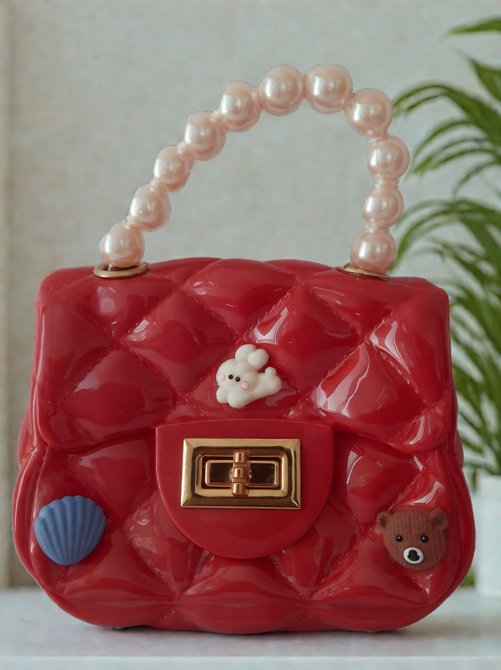 Silicon pearl sling bag with golden chain strap and pearl handle – stylish and durable mini shoulder bag for girls and women in red, available online in India.